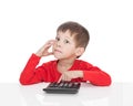 The five-year boy sitting at a white table and presses the button calculator Royalty Free Stock Photo