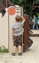 Five year old boy measuring his height on the playground Royalty Free Stock Photo