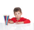 The five-year-old boy sits at a white table Royalty Free Stock Photo