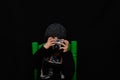 Five-year-old boy in a wool cap taking photos and selfies with an old analog camera Royalty Free Stock Photo