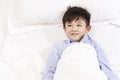 Eight year old child lying in bed in hospital ward Royalty Free Stock Photo
