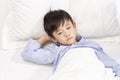 eight year old child lying in bed in hospital ward Royalty Free Stock Photo