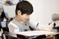 Five year old disabled boy studying in wheelchair Royalty Free Stock Photo