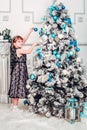 Five-year-old girl hangs toys on Christmas tree Royalty Free Stock Photo