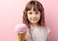 Five-year-old girl holds out her hand with ice cream