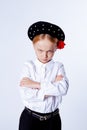 Five-year-old girl stands frowning and crosses her arms on her chest Royalty Free Stock Photo