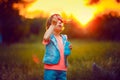 Five years old caucasian child girl blowing soap bubbles outdoor at sunset . Royalty Free Stock Photo