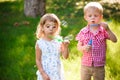 Five years old caucasian child girl and boy blowing soap bubbles Royalty Free Stock Photo