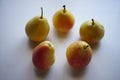 Five yellow orange pears on a white table Royalty Free Stock Photo