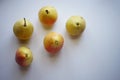 Five yellow orange pears on a white table Royalty Free Stock Photo