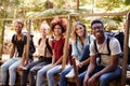 Five young adult friends on a hike sitting together smiling to camera during a break, close up Royalty Free Stock Photo