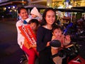 Five young asian women on a scooter