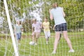 Five young friends playing soccer