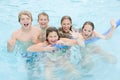 Five young friends in swimming pool playing