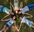 Five young ladies lounging on grassy lawn