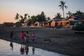 Five young local children with traditional thanaka by the riverside during sunset, Chaung Thar, Myanmar