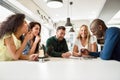 Multi-ethnic group of young people studying together on white de Royalty Free Stock Photo