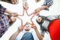 Five young smiling people make star shape from fingers Royalty Free Stock Photo