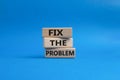 Fix the problem symbol. Wooden blocks with words Fix the problem. Beautiful blue background. Business