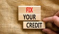 Fix your credit symbol. Concept words Fix your credit on wooden blocks on a beautiful canvas table canvas background. Businessman