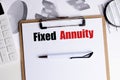 Fixed annuity concept on clipboard with pen, calculator and financial documents on office desk Royalty Free Stock Photo