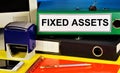 Fixed assets. Text label on the folder. Material objects that are used for a long time by the organization in the process of manag Royalty Free Stock Photo