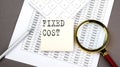 FIXED COST text on sticker on the chart ,with calculator and magnifier Royalty Free Stock Photo