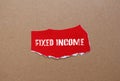 Fixed income words written on torn paper piece with brown background Royalty Free Stock Photo