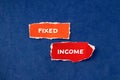 Fixed income words written on torn paper pieces with blue background Royalty Free Stock Photo