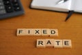 Fixed rate. Financial concepts. Wooden letters with calculator and notebook in the background Royalty Free Stock Photo