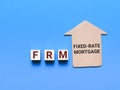 Fixed Rate Mortgage or FRM on wooden cubes with house cupboard. Royalty Free Stock Photo
