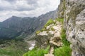 Fixed rope route in the mouintains. Exposed and dangerous trail. Royalty Free Stock Photo