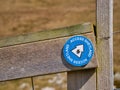 Fixed to a wooden stile, a blue and white Access Shetland near Bressay Lighthouse shows the way to walkers and hikers