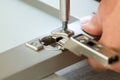 fixing cabinet door hinge Royalty Free Stock Photo