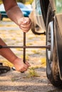Fixing car tire with rim socket wrench Royalty Free Stock Photo