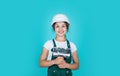 Fixing everything. kid wear helmet on construction site. teen girl plasterer with tool spatula. child on repairing work Royalty Free Stock Photo