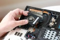 Fixing laptop. Repairman holds cooling fan and repairs from overheating. Disassembling computer, replacement, clean dust