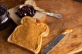 Peanut Butter and Jelly Sandwich on a Wooden Kitchen Counter Royalty Free Stock Photo