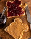 Peanut Butter and Jelly Sandwich on a Wooden Kitchen Counter Royalty Free Stock Photo