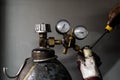 Fixing a propane gas tank. Male hands repairing a compressed cylinder of liquid gas for welding Royalty Free Stock Photo