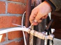 Fixing the water pipe from the outer wall of the building Royalty Free Stock Photo