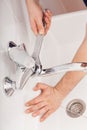 Fixing water tap with spanner Royalty Free Stock Photo