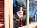 fixing window glass in wooden frame using hammer Royalty Free Stock Photo