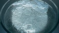 Fizzy drink bubbling inside container closeup. Sparkling aqua glass macro view