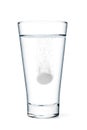 Fizzy tablet in glass of water Royalty Free Stock Photo