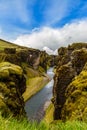 Fjadrargljufur canyon steep cliffs and waters of Fjadra river, s