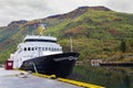 Fjord cruise boat moored on Mountainous Norway landscape Royalty Free Stock Photo
