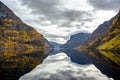 Fjord and Mountains in the autumn season that reflect the water Royalty Free Stock Photo