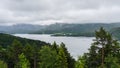 Fjord in Norway on a rainy day surrounded by mountains and trees in the foreground Royalty Free Stock Photo