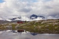 Fjords of Norway. Water in the fjords of Norway, stones on the shore, the sky is reflected in the water, clouds.